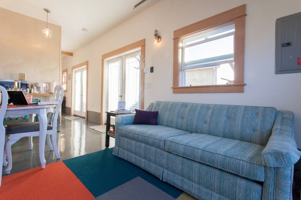 Open concept living area with kitchenette. Pull out sofa bed that won't put a dent in your back :)