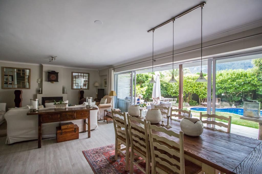 open plan lounge dining kitchen with glass sliders onto a wooden deck and pool.....size of the small front garden,surrounded by trees for privacy