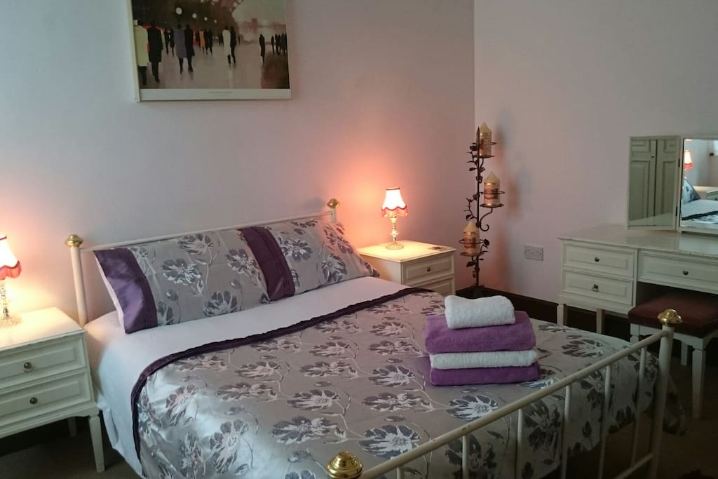 large bedroom with double bed and bunk beds.