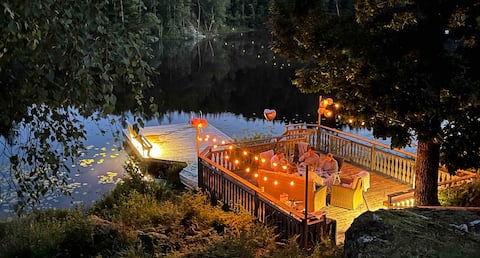 Cottage with private dock by a lake.