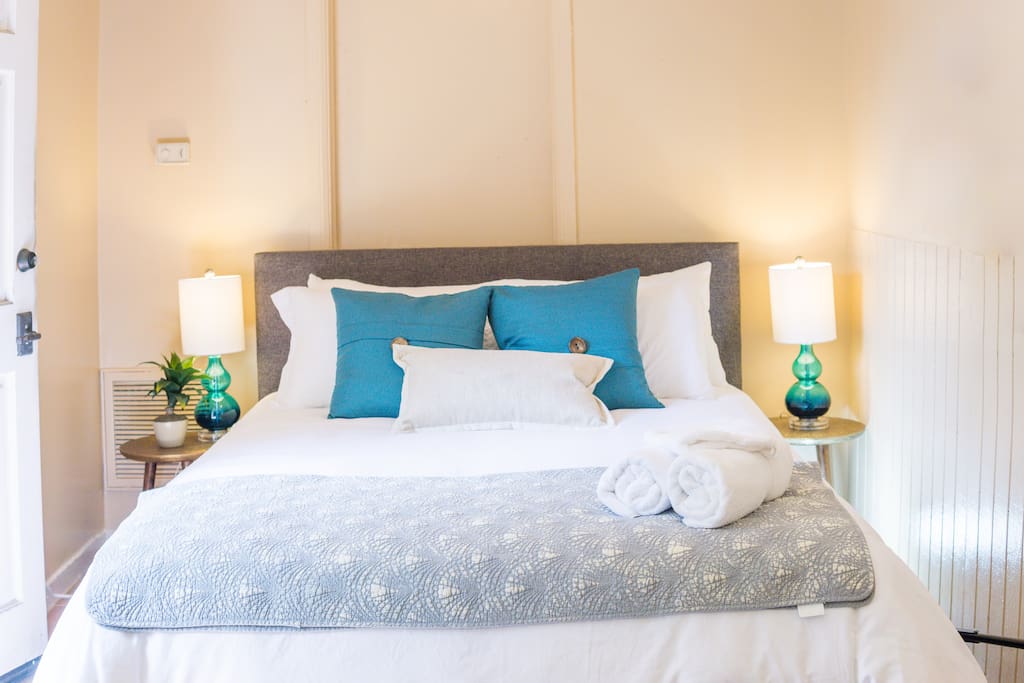 Queen size bed with fresh sheets; hand, face and bath towels