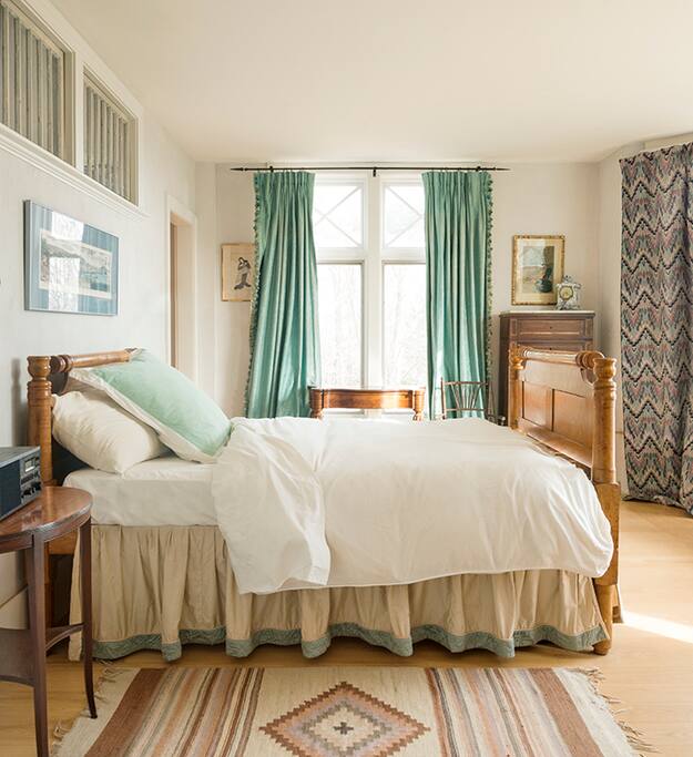 Master bedroom with views down the hill to apple orchard, and sheep flock.