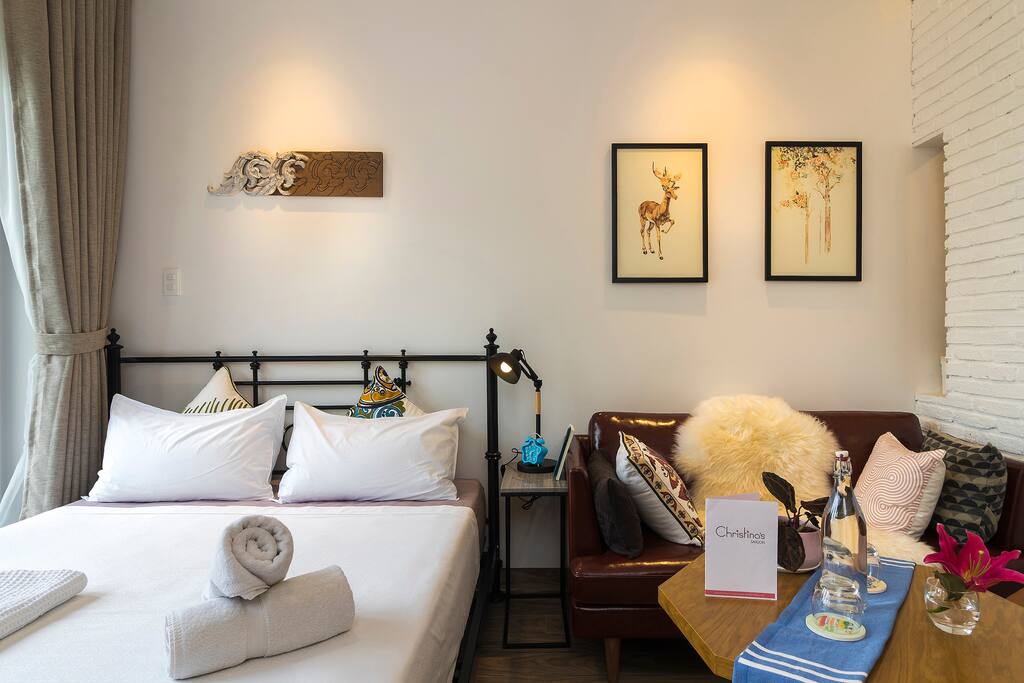 High quality couch next to the bed. Why not picking up a book and enjoy it?