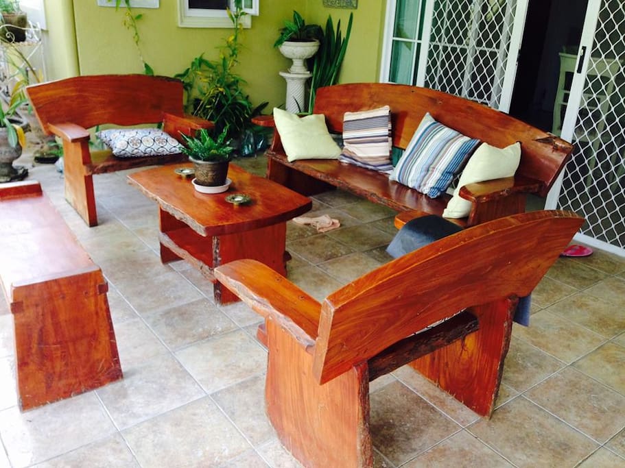 Lanai area with real wood furniture facing the garden.