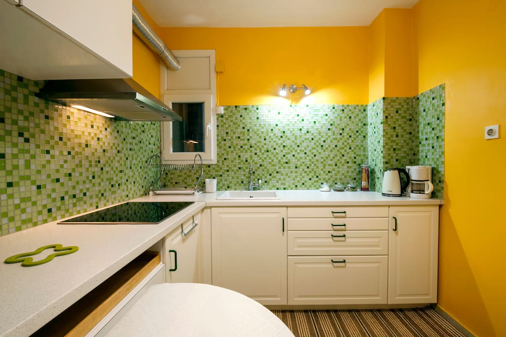 The kitchen. The ceramic cooker on the left and on the right a coffee maker, a water boiler and coffee, sugar, candies and pasta available fr the guests. The drawers and cupboards that can be seen here are all available to the guests and are full of utensils, plates, cups, cooking pots, etc.