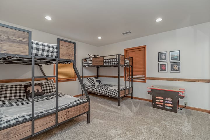 Two Sets of Bunkbeds, perfect for all of the kids! One set is twin over twin and one set is twin over full sized. There is also a table arcade game for your enjoyment in this room!!