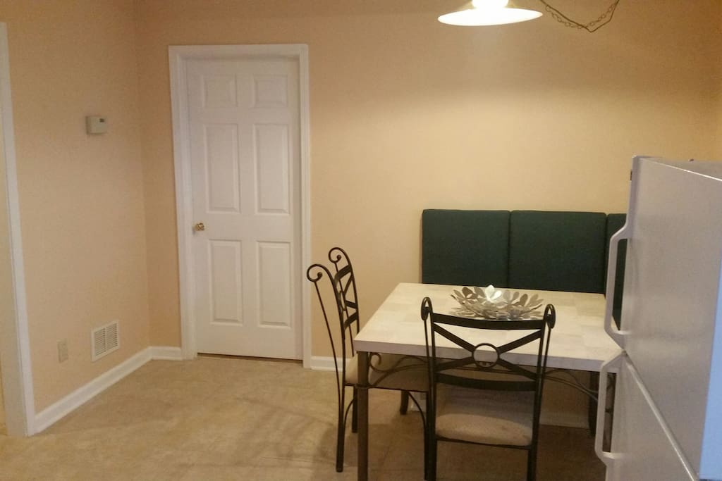 Full size refrigerator in kitchen. Door connects to TV and sitting room