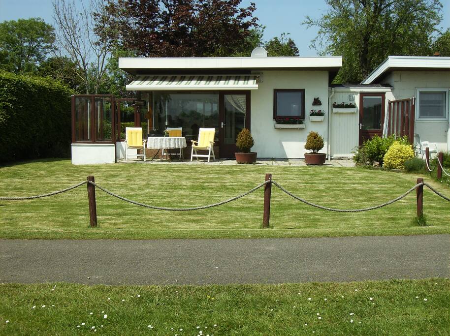 large front patio with electric awning and furniture for 5 guests
