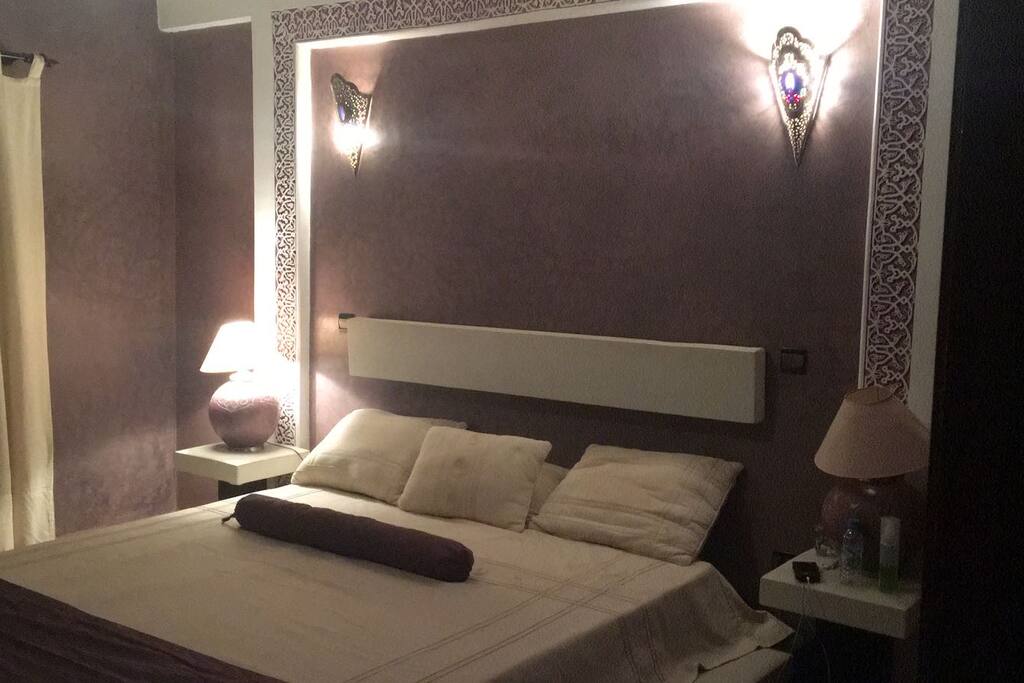 Lilac painted large bedroom.