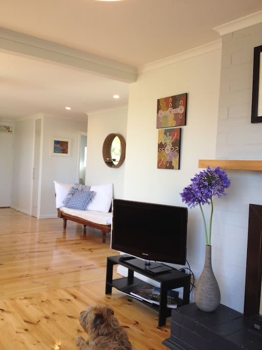 Cosy lounge room with a wood burning fireplace and air conditioning