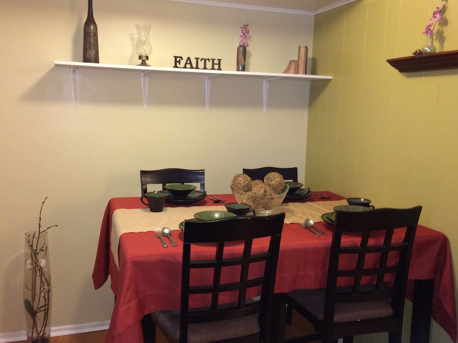 High dining table with stoneware dinner set and silverware.