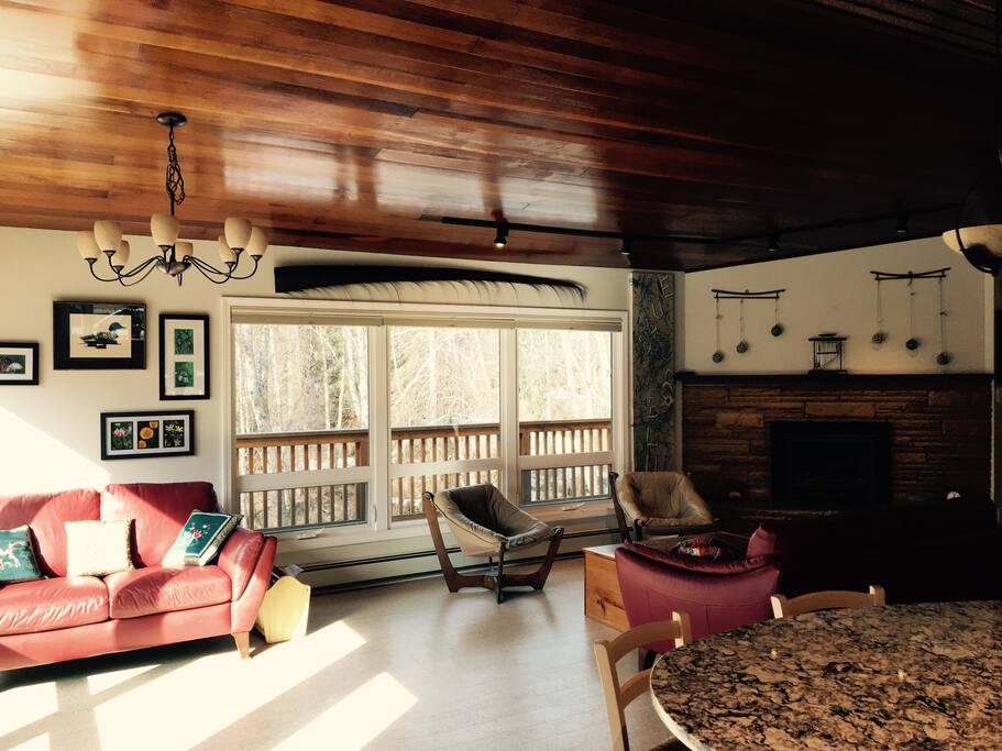 COMMON AREA
Spacious, comfortable and bright shared sitting area with fireplace overlooking Hood Creek. Regular wild residents and visitors include moose, eagles, owls, ravens, and a wide variety of other native birds, fox, and black bear.