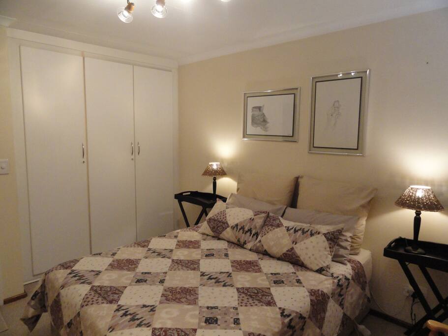 Different view of bedroom showing the build in cupboards.