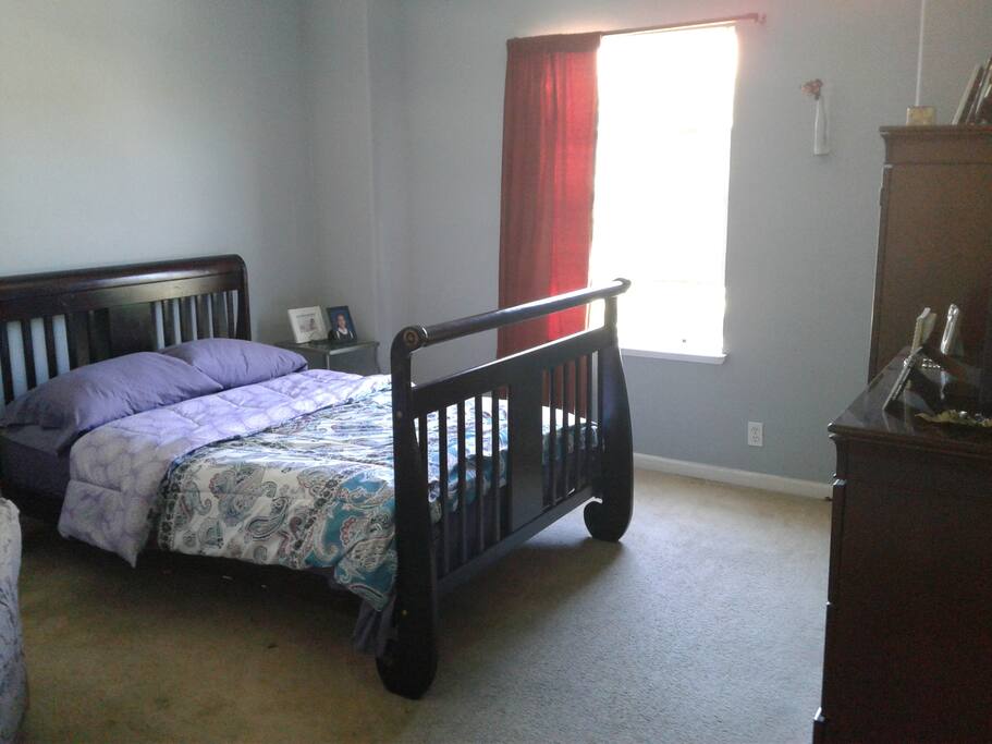 Guest bedroom also has a small sofa in it.