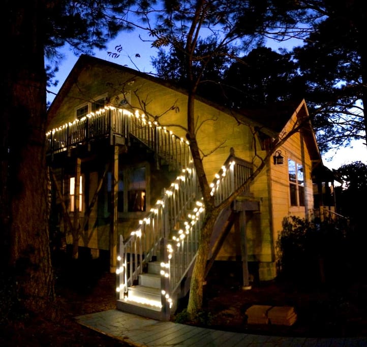 House balcony entrance well-lit by charming lights