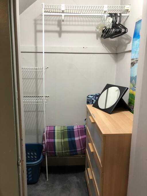 The walk-in closet ... hangers, laundry basket and shoe organizer are provided.