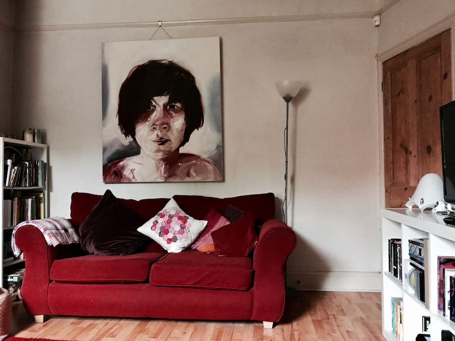 Comfy lounge with books for you to read, comfortable sofa and warm lighting.
