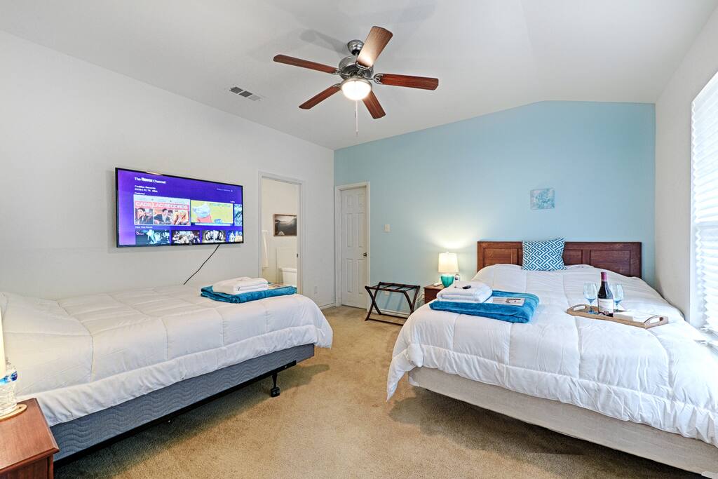 Master Bedroom has 2 Queen Beds with headboards and a 55" Wall-Mounted 4K TV!