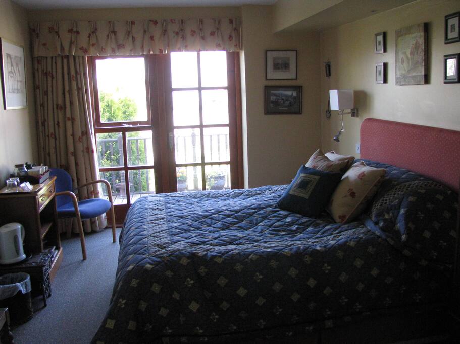 Bedroom has French windows opening onto decking and back garden