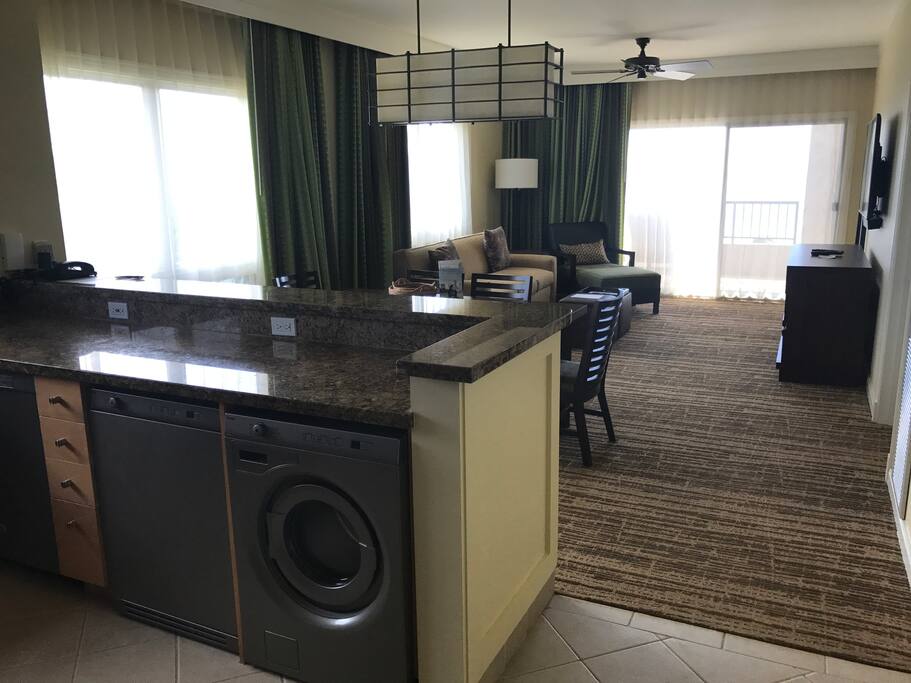 View from Kitchen to dining room and living room with washer and dryer