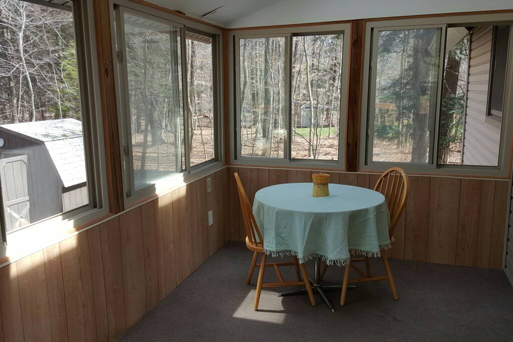 Three season room with skylights and a breakfast table.
