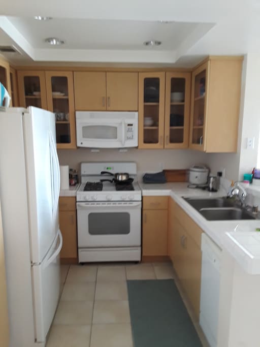 Kitchen with fridge, microwave, oven, washing machine, Nespresso machine