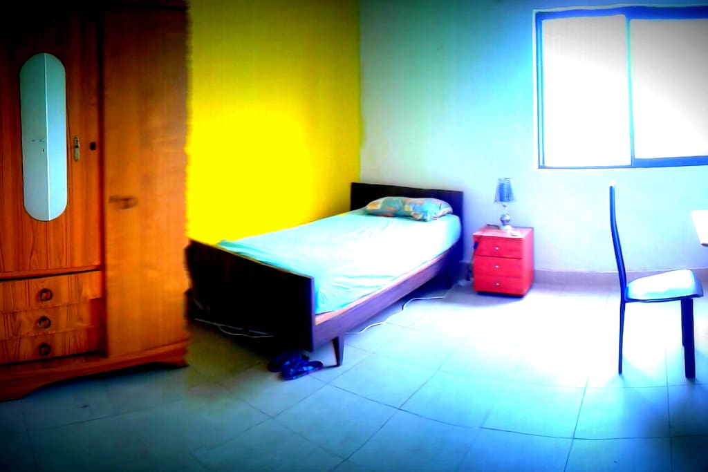 single bedroom with air conditioner and desk