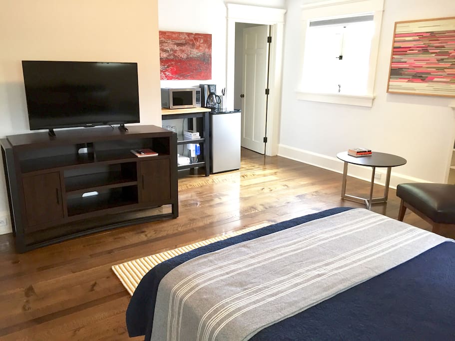 Large flat screen televison with Apple TV. Door on the right is the entrance to a sizable walk-in closet