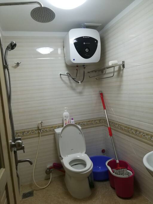 modern and clean bathroom with rain shower and hot and cold water