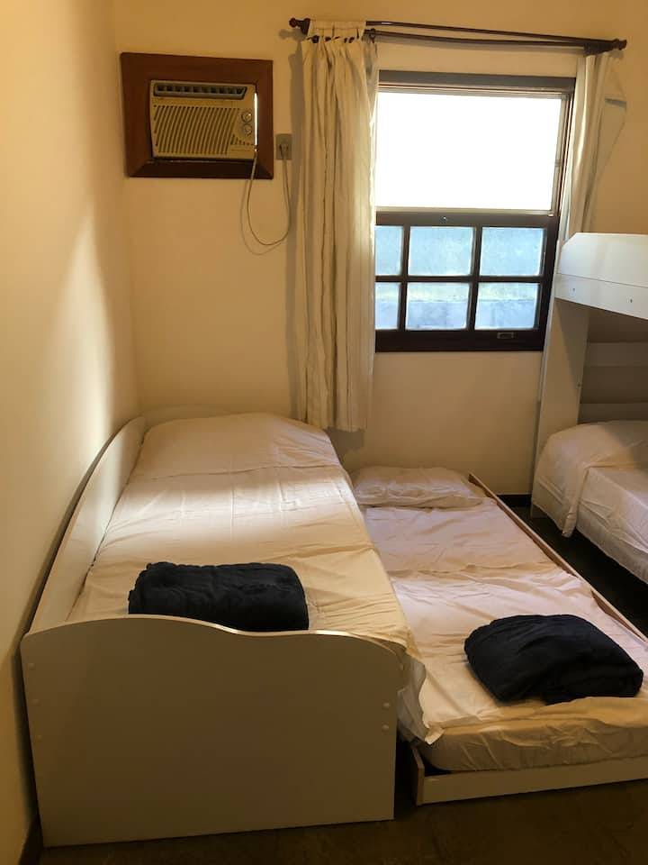 „საბავშვო“ ოთახი. აღჭურვილია ორადგილიანი საწოლით + ორსართულიანი საწოლითა და კარადით, ასევე, კონდიციონერითა და ჭერის ვენტილატორით. Ხედი სახლის უკანა მხარეს.