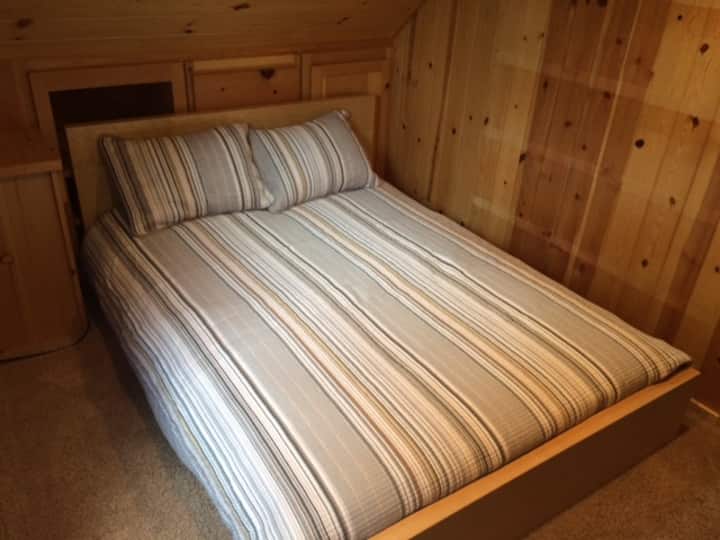 Upstairs bedroom #2 with a comfortable full size bed and tucked away a cubby twin bed