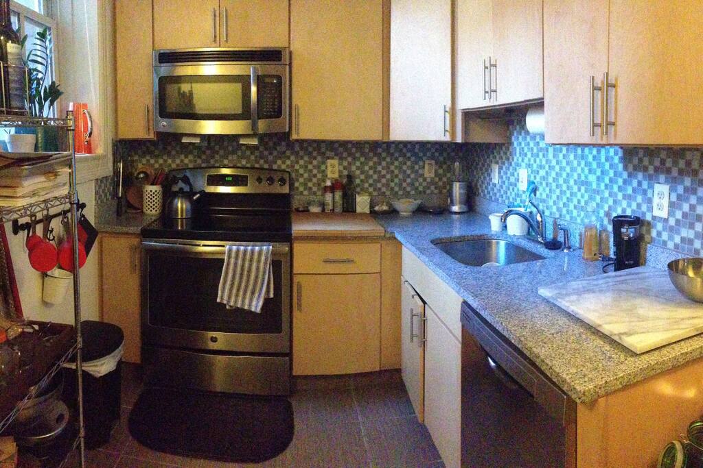 Fully stocked kitchen with natural light, granite counters, and updated appliances