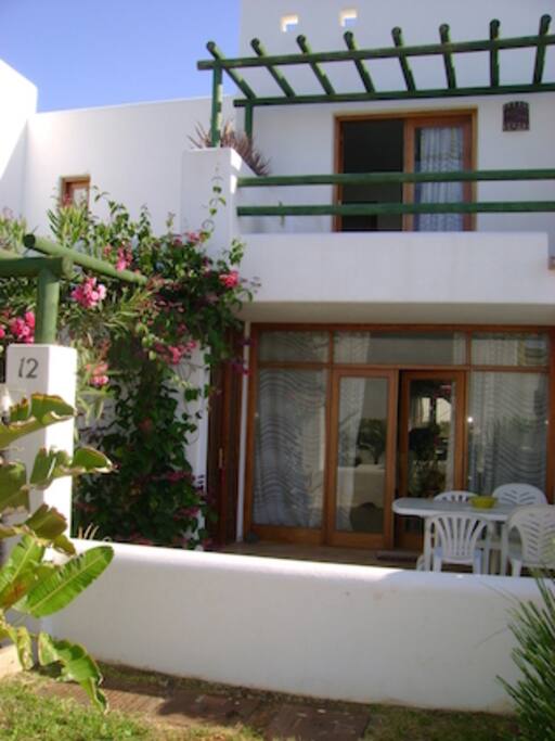 Downstairs patio with view of the garden and pool.