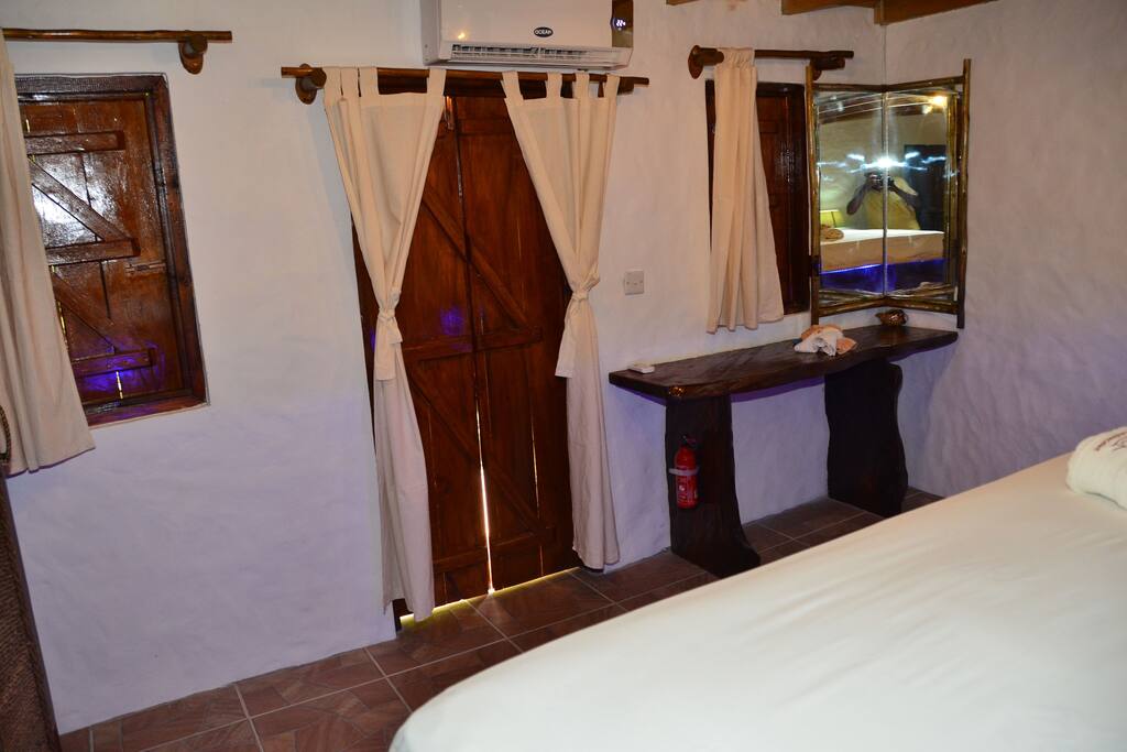 Bedroom downstairs with Creole style rustic windows