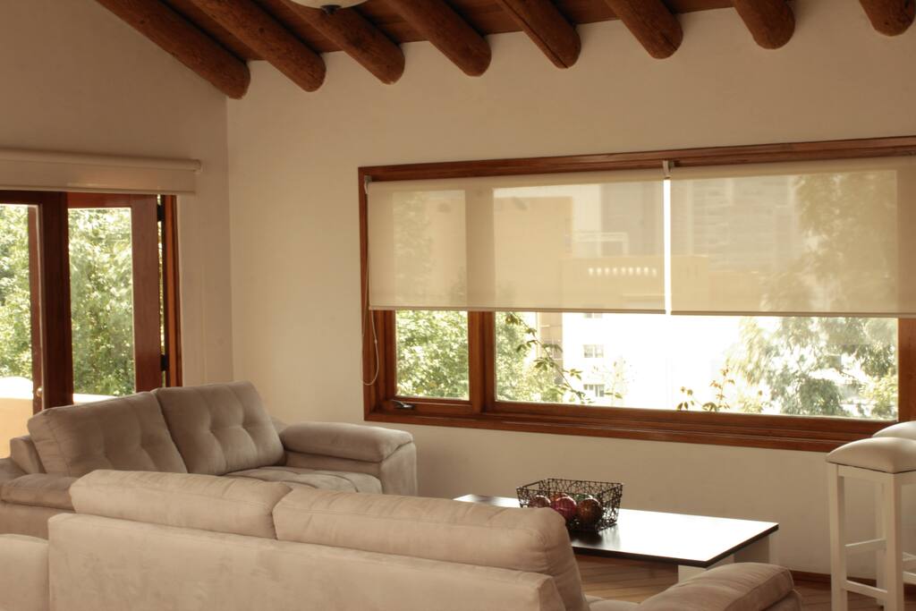 Spacious living room/bar/dining room space with ample, unobstructed view of Santa Fe neighborhood outside