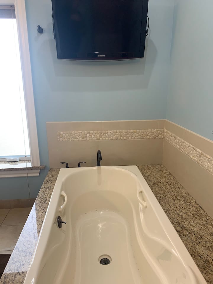 Owners suite personal bath with tv and view of Lake Erie