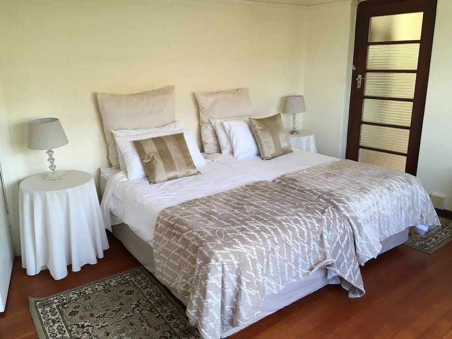 First Bedroom. 2 single beds, ample cupboard space, light and spacious. Beautiful wooden flooring