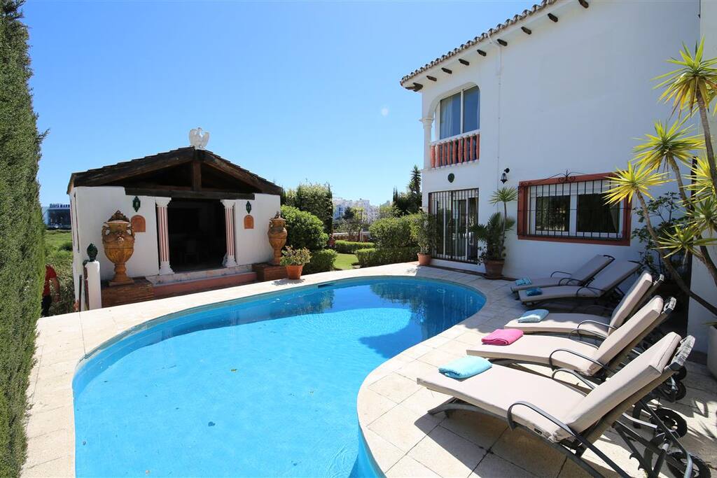 Kidney shaped pool. Seven sunbeds available to clients