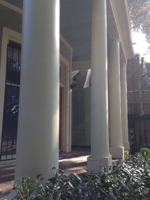 Strong, rounded columns border the front porch.