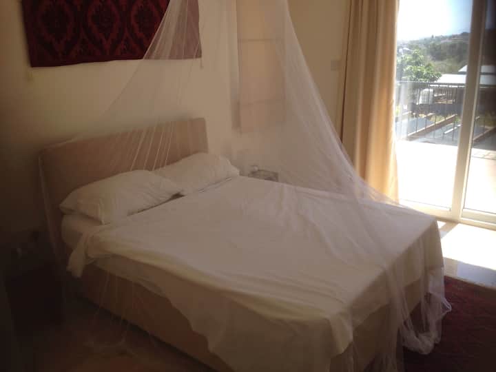 Main bedroom also has ensuite bathroom and large balcony looking out to sea.