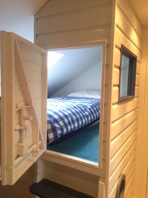 Our son's ship bed. It was made to measure and included an adult size single bed mattress. The little bed has lighting in the inside and a ladder to reach the den at the bottom. We have a blow up bed for sleep overs and it's always a real hit. Strong enough for an adult to carefully climb inside. The bed is his pride and joy - so please play here respectfully.