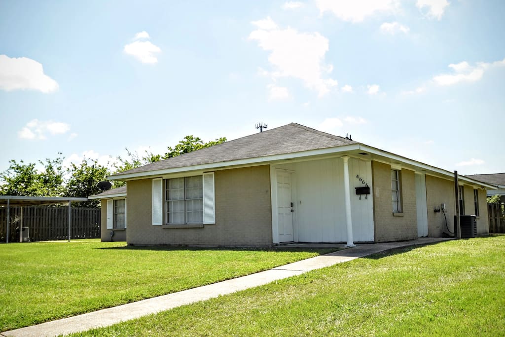 Large front yard with carport & parking for 2 cars.
