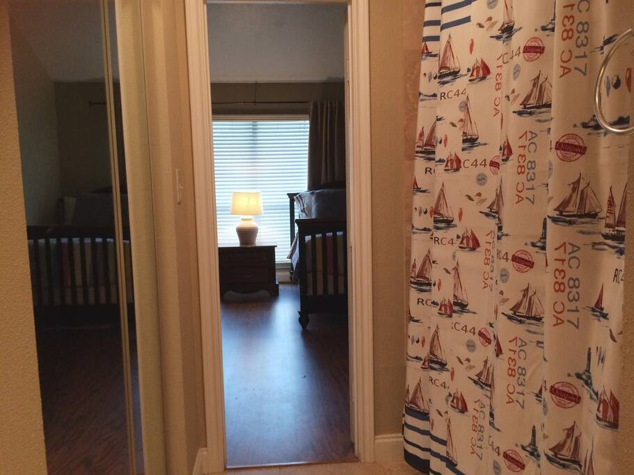 The downstairs bedroom joins the bathroom with a tub and shower.