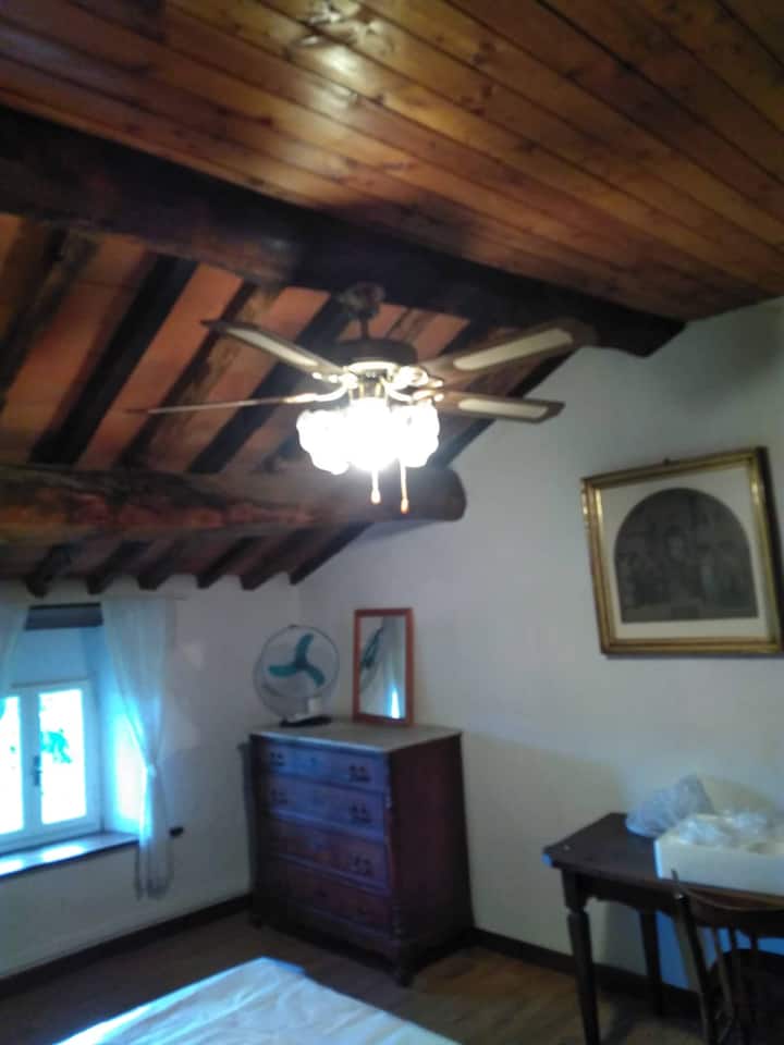 Bedroom on the second floor with ceiling fan and moscito net