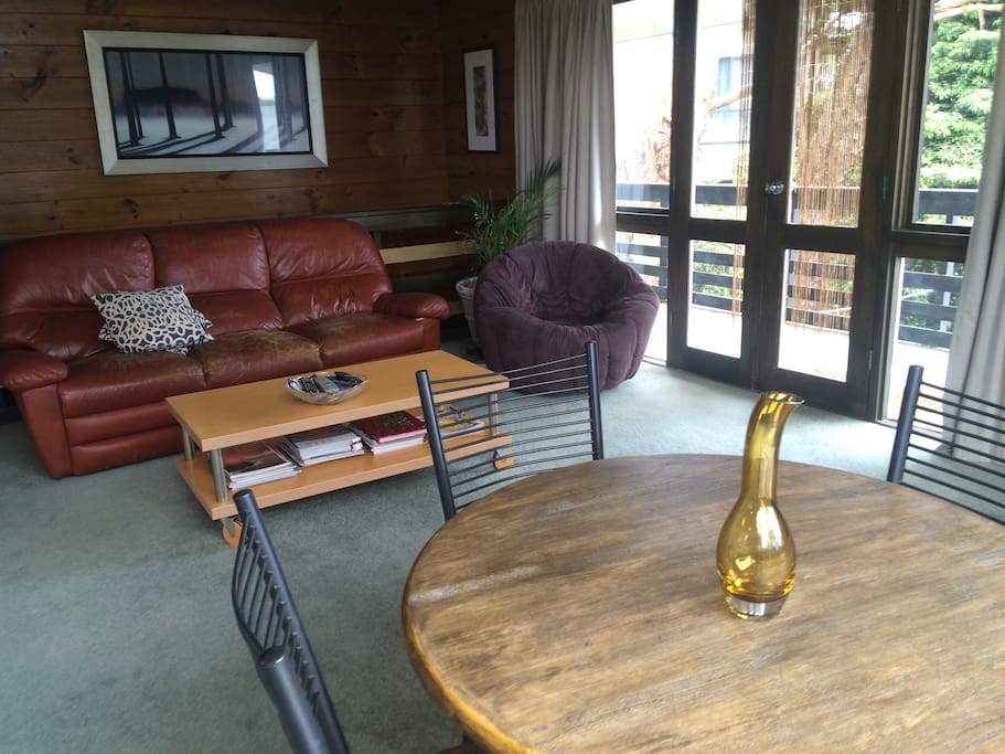 Upstairs open plan living arrea with balcony access.