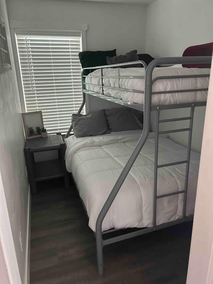 Small guest bedroom with a full/twin bunk bed.