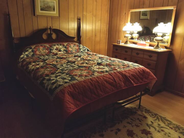 Queen-size bed in bedroom 1.