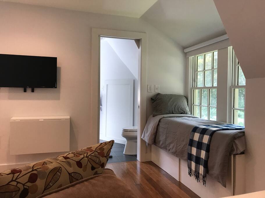 Wall mounted TV with Roku TV.