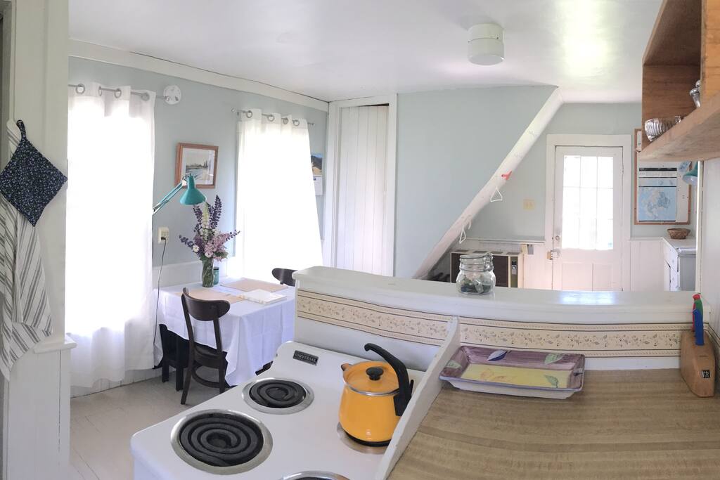 Kitchen area and dining/living area behind.