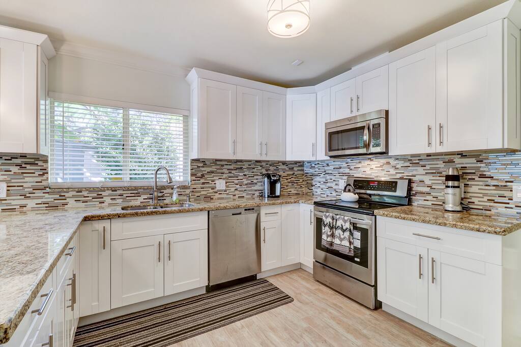 Open and airy kitchen that is well equipped.